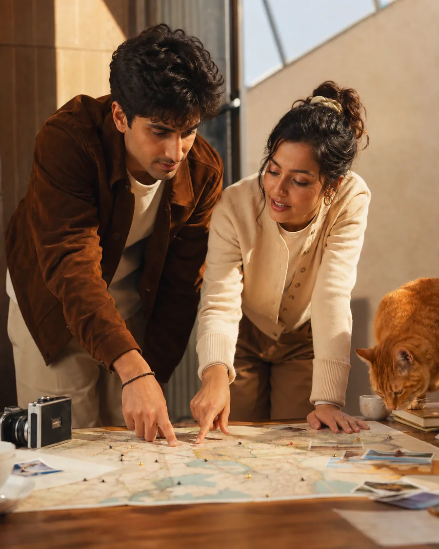 A couple leaning over a map together, planning